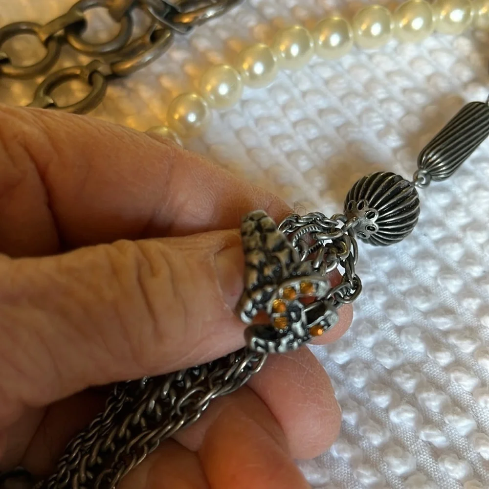 Women’s double chain belt. One of metal objects and the second chain of pearls.